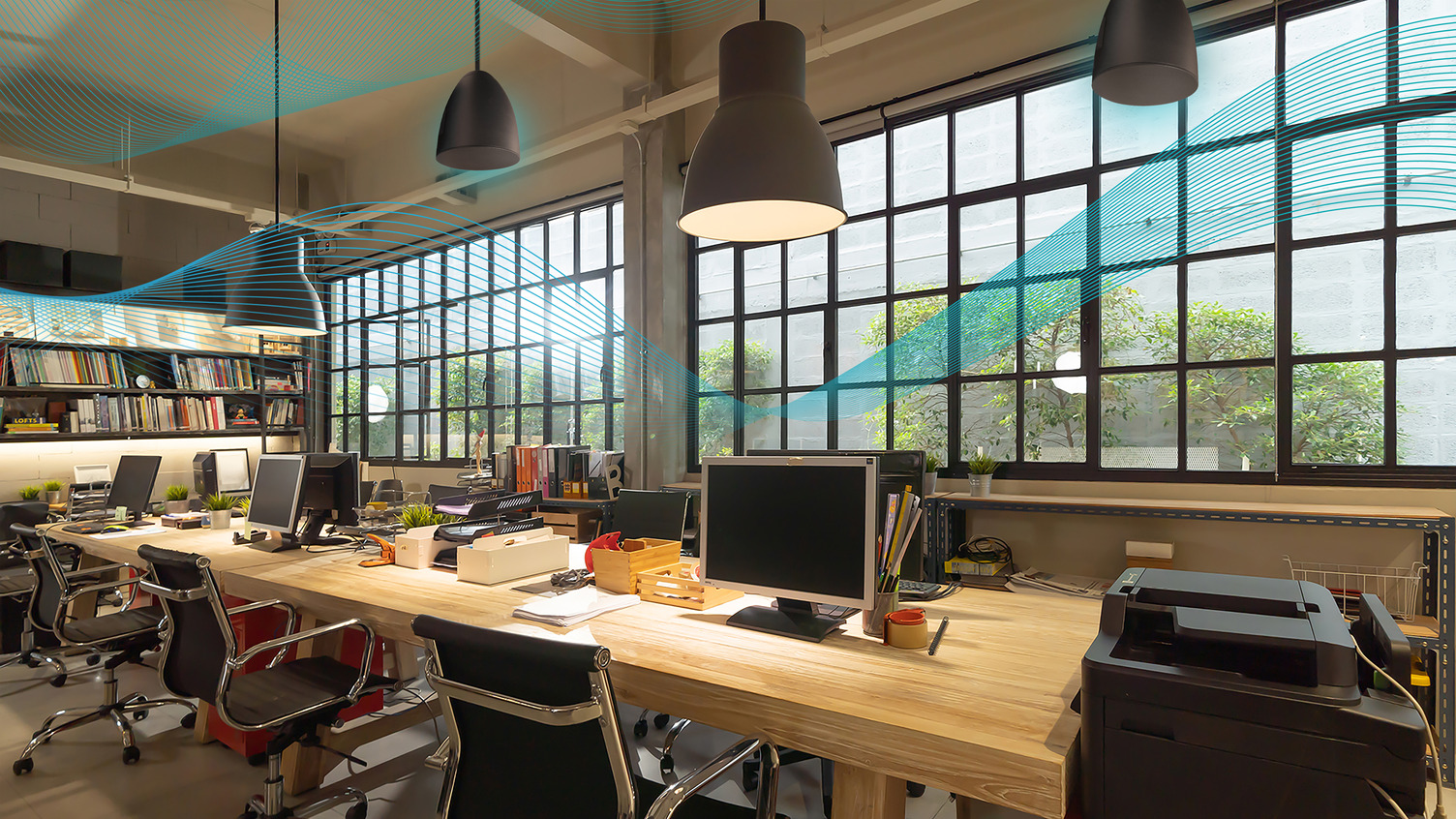 An office with Bluesound Professional BCS300 speakers inside a pendant kit